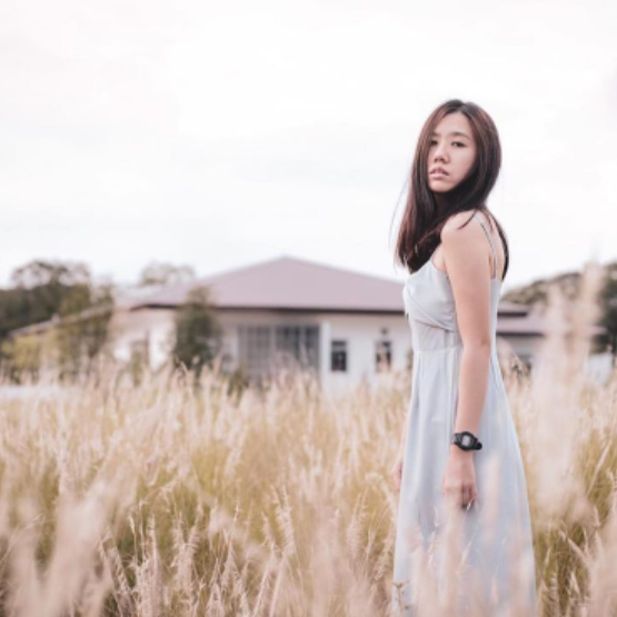 Lady standing amidst lalang field at Lakeside Gardens